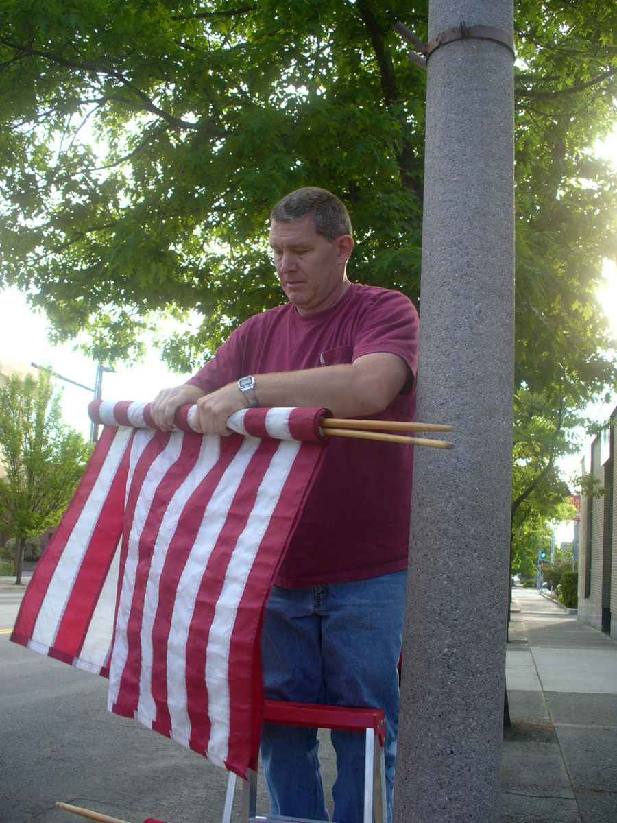 Man hanging flag by Susan Fluegel
